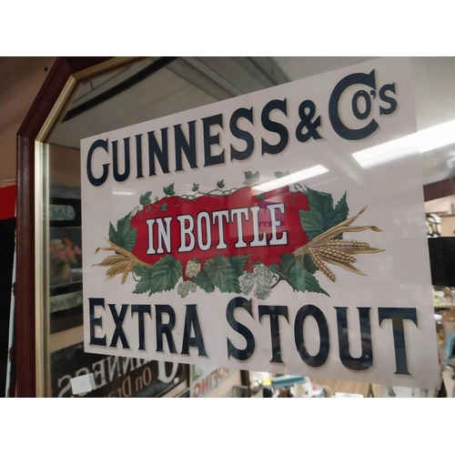 188 - Guinness Extra Stout In Bottle framed advertising mirror. {55 cm H x 68 cm W}.