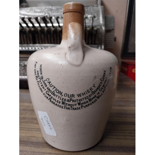 200 - Cruskeen Lawn stoneware advertising flagon. {20 cm H x 13 cm Diam}.