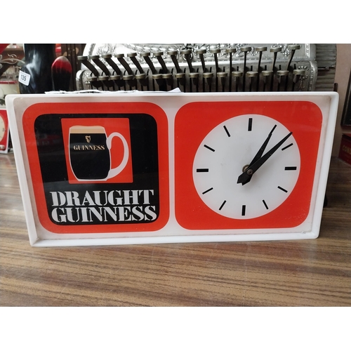 210 - Draught Guinness Perspex battery advertising clock. {18 cm H x 27 cm W x 8 cm D}.