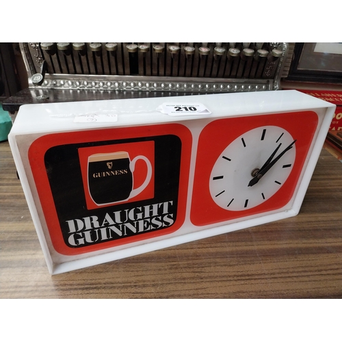 210 - Draught Guinness Perspex battery advertising clock. {18 cm H x 27 cm W x 8 cm D}.