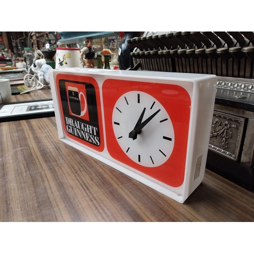 210 - Draught Guinness Perspex battery advertising clock. {18 cm H x 27 cm W x 8 cm D}.