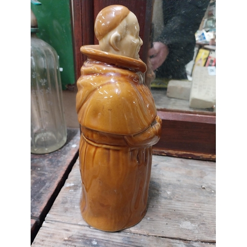 22 - Two Scotch Whiskey ceramic advertising bottles in the form of Monks. {28 cm H x 10 cm Dia.}.