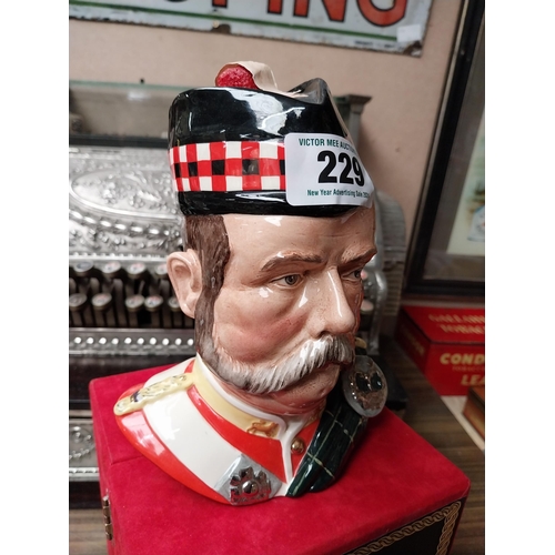 229 - Grants 25 year old Scotch Whiskey in Royal Doulton figure. {19 cm H x 15 cm W x 15 cm D}.