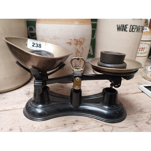 238 - Brass and cast iron Sweet scales with weights. {16 cm H x 29 cm W x 19 cm D}.