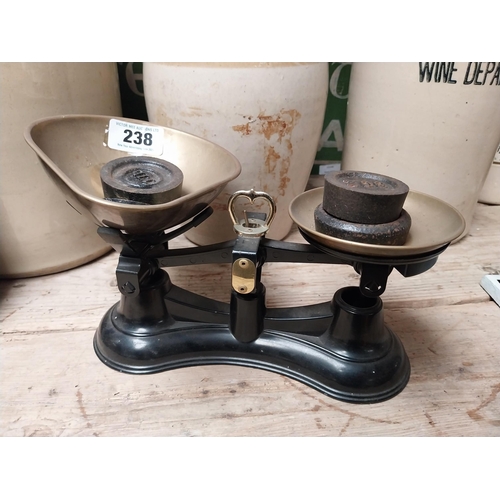 238 - Brass and cast iron Sweet scales with weights. {16 cm H x 29 cm W x 19 cm D}.