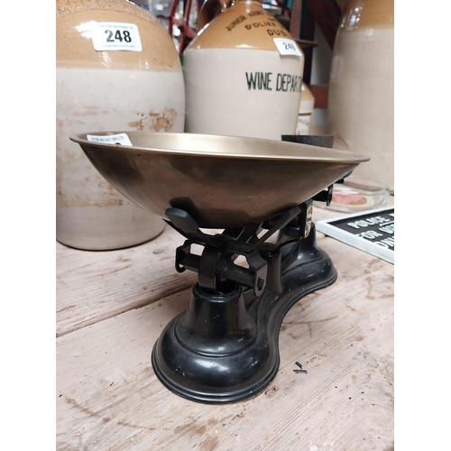 238 - Brass and cast iron Sweet scales with weights. {16 cm H x 29 cm W x 19 cm D}.