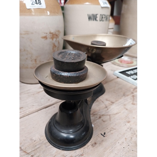 238 - Brass and cast iron Sweet scales with weights. {16 cm H x 29 cm W x 19 cm D}.