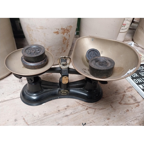 238 - Brass and cast iron Sweet scales with weights. {16 cm H x 29 cm W x 19 cm D}.