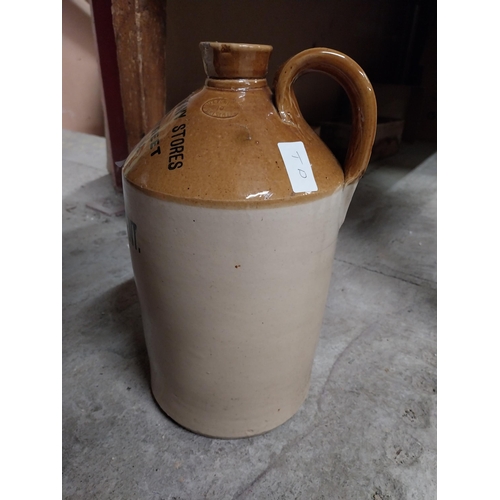 249 - Army and Navy Stores Dublin Wine Dept stoneware flagon. {24 cm H x 18 cm Dia.}.