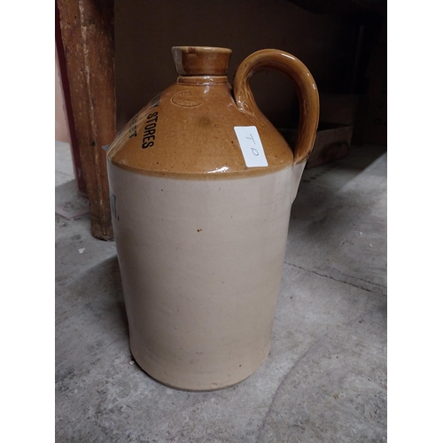 249 - Army and Navy Stores Dublin Wine Dept stoneware flagon. {24 cm H x 18 cm Dia.}.