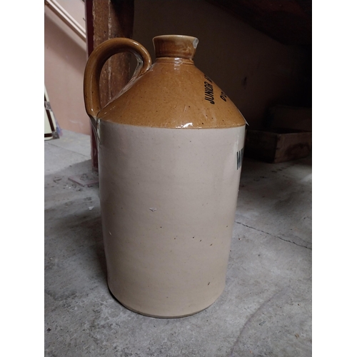 249 - Army and Navy Stores Dublin Wine Dept stoneware flagon. {24 cm H x 18 cm Dia.}.