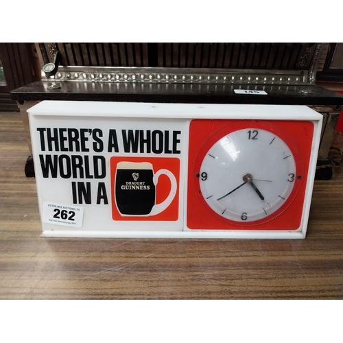 262 - There's a whole world in Guinness Perspex battery advertising clock. {15 cm H x 32 cm W x 8 cm D}.