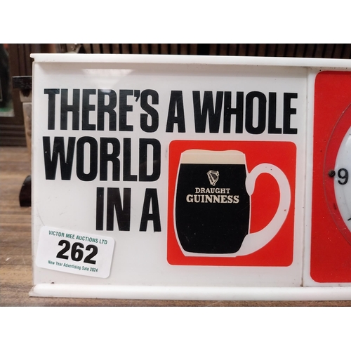 262 - There's a whole world in Guinness Perspex battery advertising clock. {15 cm H x 32 cm W x 8 cm D}.