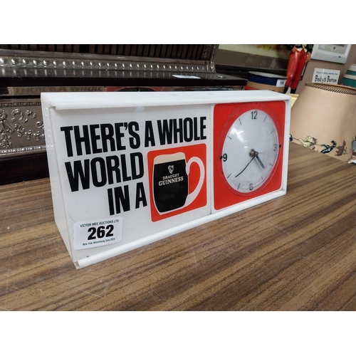 262 - There's a whole world in Guinness Perspex battery advertising clock. {15 cm H x 32 cm W x 8 cm D}.