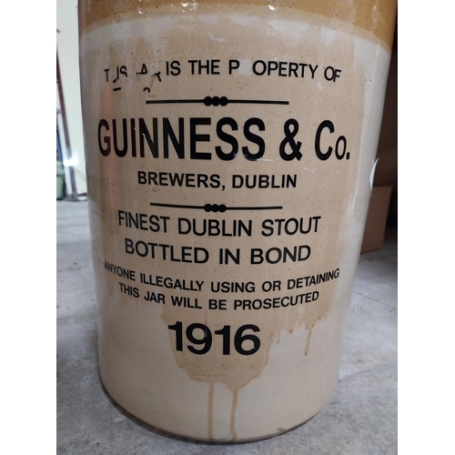 264 - Guinness and Co four gallon stoneware whiskey flagon. {47 cm H x  26 cm Dia.}.