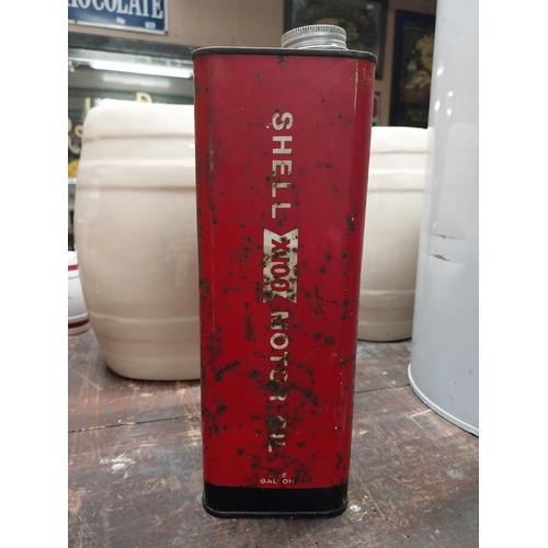 285 - Shell X 100 metal oil can. {21 cm H x 16 cm W x 10 cm D}.