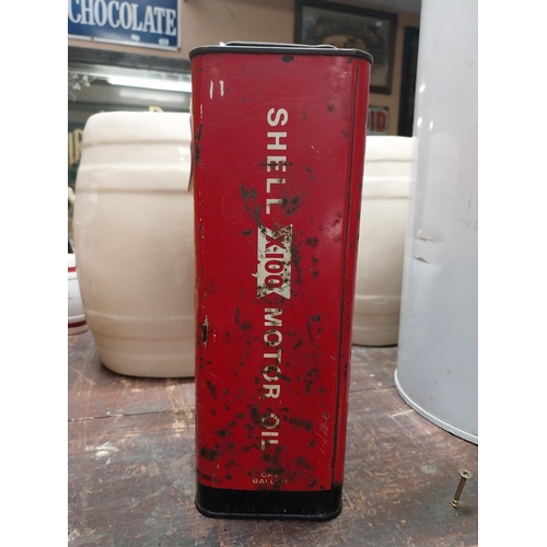 285 - Shell X 100 metal oil can. {21 cm H x 16 cm W x 10 cm D}.