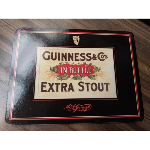 308 - Seven Guinness beer mats various sizes. {22 cm H x 30 cm W  to 10 cm H x 10 cm W}.