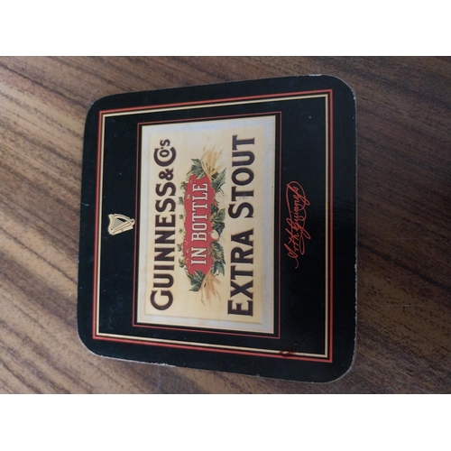 308 - Seven Guinness beer mats various sizes. {22 cm H x 30 cm W  to 10 cm H x 10 cm W}.