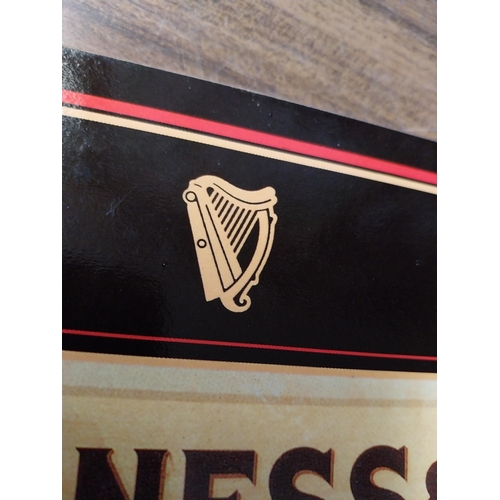 308 - Seven Guinness beer mats various sizes. {22 cm H x 30 cm W  to 10 cm H x 10 cm W}.