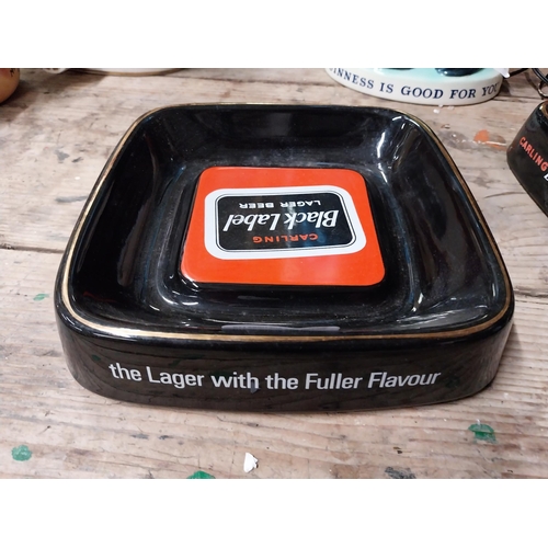 33 - Two Carling Black Label ceramic advertising ashtrays by Royal Norfolk. {5 cm H x 21 cm W}.