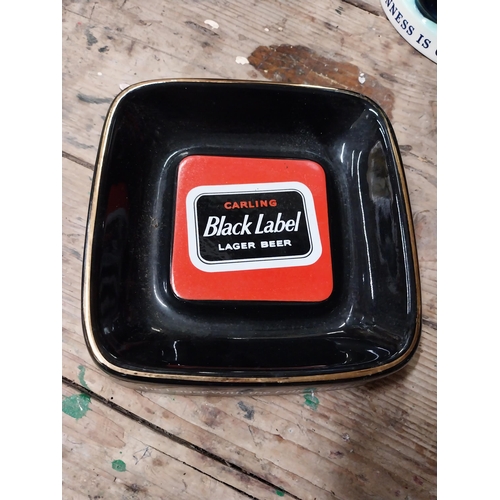 33 - Two Carling Black Label ceramic advertising ashtrays by Royal Norfolk. {5 cm H x 21 cm W}.