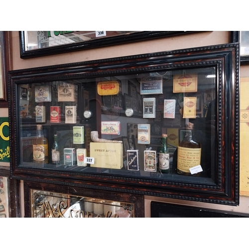 337 - Framed collage of Whiskey bottles, Cigarettes boxes and pipes etc. {51 cm H x 96 cm W}.