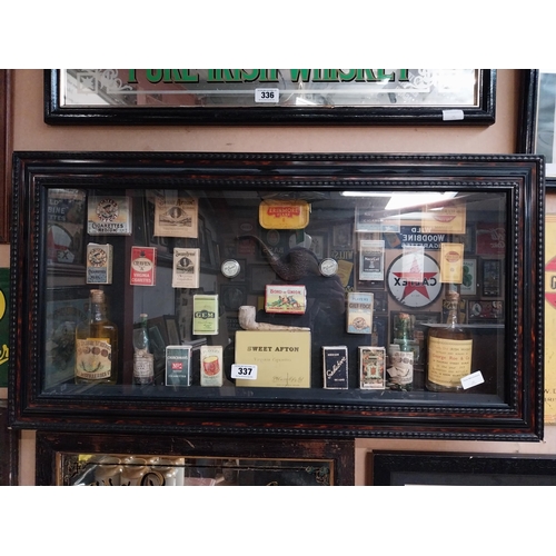 337 - Framed collage of Whiskey bottles, Cigarettes boxes and pipes etc. {51 cm H x 96 cm W}.