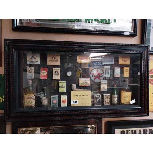 337 - Framed collage of Whiskey bottles, Cigarettes boxes and pipes etc. {51 cm H x 96 cm W}.