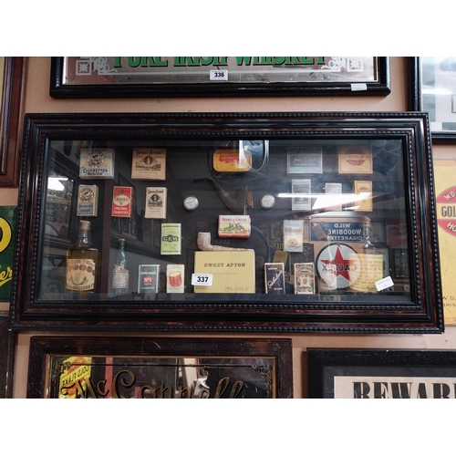 337 - Framed collage of Whiskey bottles, Cigarettes boxes and pipes etc. {51 cm H x 96 cm W}.