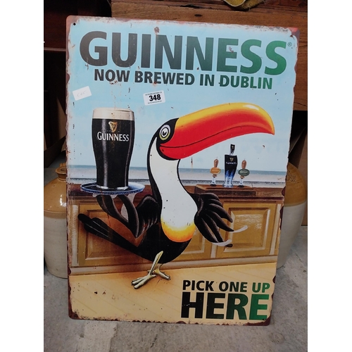 348 - Tin plate Guinness Now Brewed in Dublin advertising sign. {50 cm H x 38 cm Dia.}.