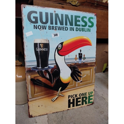 348 - Tin plate Guinness Now Brewed in Dublin advertising sign. {50 cm H x 38 cm Dia.}.