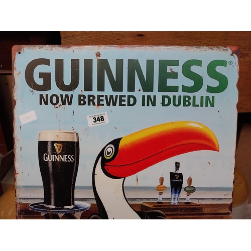 348 - Tin plate Guinness Now Brewed in Dublin advertising sign. {50 cm H x 38 cm Dia.}.