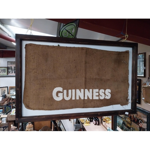 408 - Guinness sack cloth mounted on wooden frame. {76 cm x 115 cm W