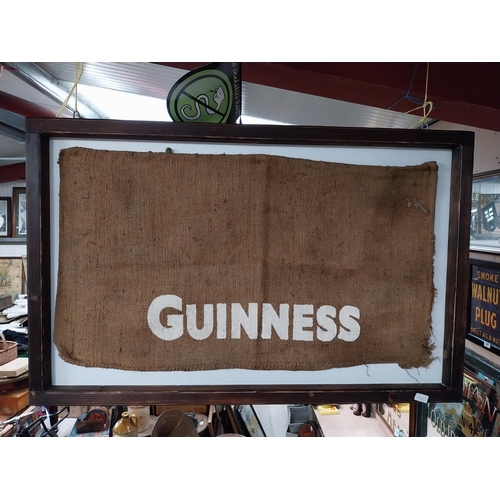 408 - Guinness sack cloth mounted on wooden frame. {76 cm x 115 cm W