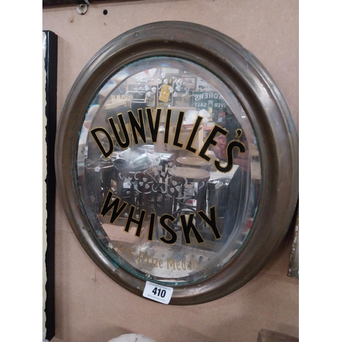 410 - Original Dunville's Whiskey oval mirror mounted in brass frame {44 cm H x 34 cm W}.