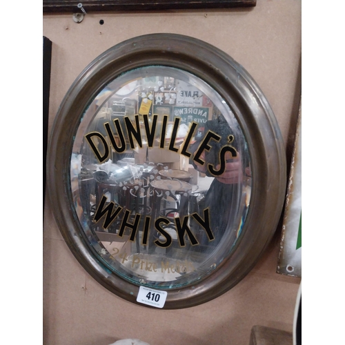 410 - Original Dunville's Whiskey oval mirror mounted in brass frame {44 cm H x 34 cm W}.