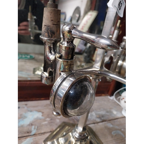 43 - Early 20th C. chrome and brass three bottle optic stand with original optics. {91 cm H x 31 cm W x 2... 