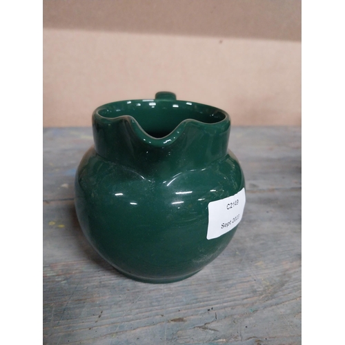 443 - Two Wade ceramic water jugs. {10 cm H x 15 cm W x 10 cm D}.