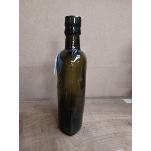 463 - Findlater Dublin rolled top half pint advertising bottle. {19 cm H x 8 cm W x 5 cm D}