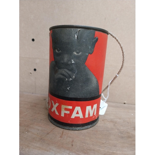 468 - Oxfam Oxford Committee collection tin. {14 cm H x 9 cm Dia.}.