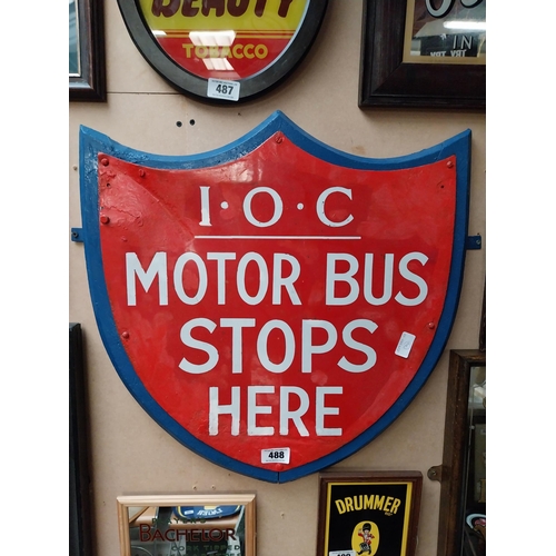 488 - IOC Motor Bus Stops Here enamel and wooden sign in the form of Shield. {59 cm H x 57 cm W}