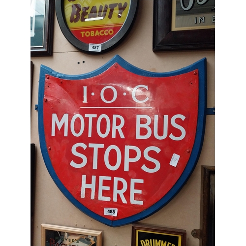 488 - IOC Motor Bus Stops Here enamel and wooden sign in the form of Shield. {59 cm H x 57 cm W}