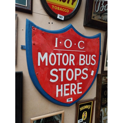 488 - IOC Motor Bus Stops Here enamel and wooden sign in the form of Shield. {59 cm H x 57 cm W}