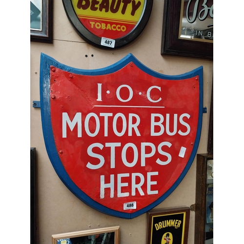 488 - IOC Motor Bus Stops Here enamel and wooden sign in the form of Shield. {59 cm H x 57 cm W}