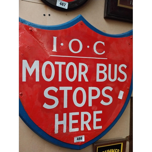 488 - IOC Motor Bus Stops Here enamel and wooden sign in the form of Shield. {59 cm H x 57 cm W}