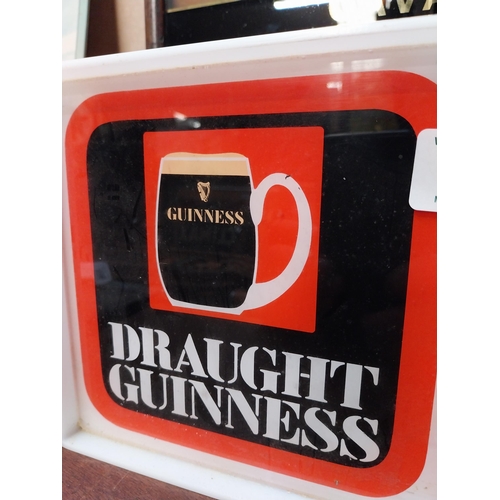 495 - 1970's Draught Guinness Perspex battery advertising clock. {18 cm H x 36 cm W x 7 cm D}.