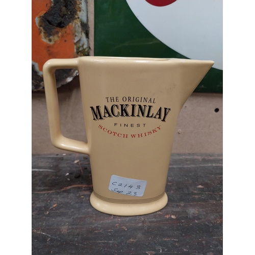 5 - Mackinlays Scotch Whiskey ceramic advertising water jug. {16 cm H x 16 cm W x 6 cm D}.