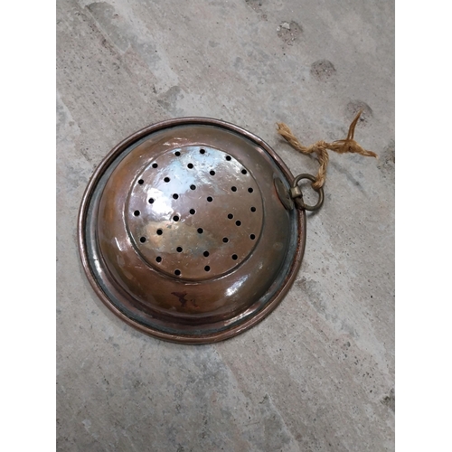 528 - Collection of 19th C. copperware including colanders and jelly moulds.