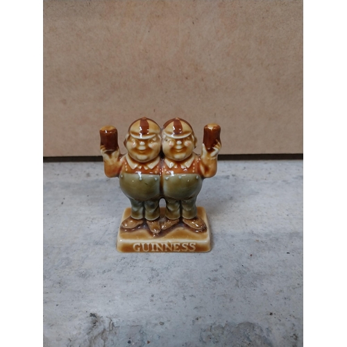 605 - Four miniature ceramic Guinness advertising figures. {9 cm H} approx.